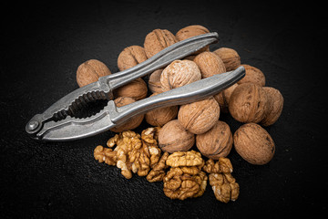 Lot of whole ripe brown walnut  on black