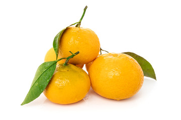 Ripe mandarines with leaves close-up on a white background