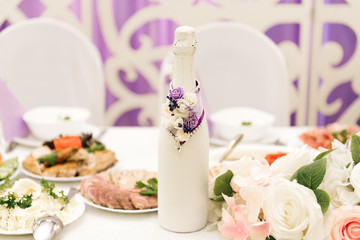 The concept of decor for weddings and holidays, floral arrangements on the tables, the Presidium of the newlyweds in purple