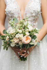 Bridal morning details. Wedding beautiful bouquet in the hands of the bride, selectoin focus