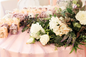 The concept of decor for weddings and holidays, floral arrangements on the table of fresh flowers.  The Presidium of the newlyweds
