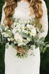 Bridal morning details. Wedding beautiful bouquet in the hands of the bride, selectoin focus