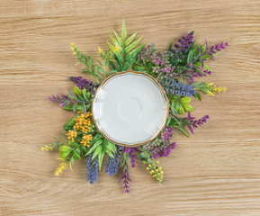 Wildflowers and empty white porcelain plate