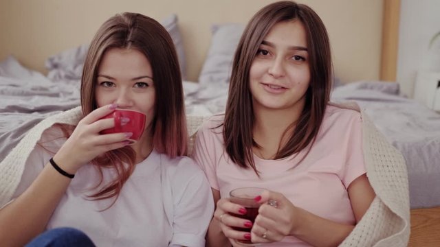 Girls friendship. Close relationship. Two happy besties enjoying watching movie together.
