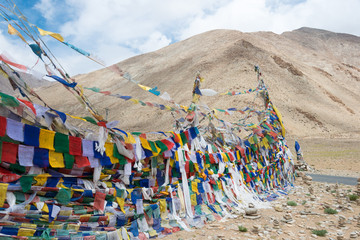 Ladakh, India - Jul 12 2019 - Tibetan prayer flag at Kiagar La Pass in Ladakh, Jammu and Kashmir, India. Kiagar La is situated at an altitude of around 4843m above the sea level.