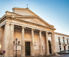 Obraz premium The cathedral of San Pietro Apostolo in Isernia. The facade with a large triangular tympanum in travertine, supported by pillars and columns with Ionic capitals. The portal with bas-reliefs.