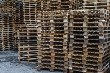 Big stack of wooden pallets at warehouse