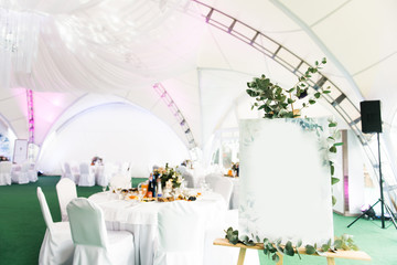 The concept of decoration for wedding and celebration, map of the Seating is decorated with branches of flowers, copy space for text