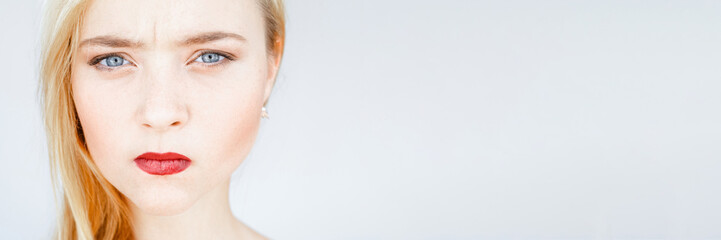 Fototapeta premium Anger, offence. Annoyed, mad, disappointed woman Smooth face skin red lips
