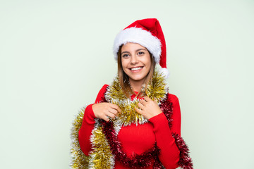 Girl with christmas hat over isolated green background
