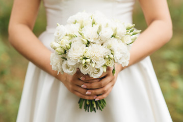 Bridal morning details. Wedding beautiful bouquet in the hands of the bride, selectoin focus