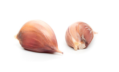 many garlic cloves on a white background