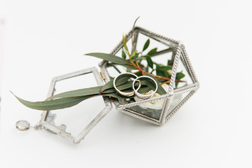 Fototapeta premium Wedding rings in a box with flowers, decor and details of the wedding ceremony, selective focus, macro