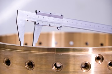 Precisely manufactured bronze product, machining and metal dimension measurement.