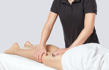 Masseur makes anti-cellulite massageon the legs, thighs, hips and buttocks in the spa. Overweight treatment, body sculpting.Cosmetology and massage concept.