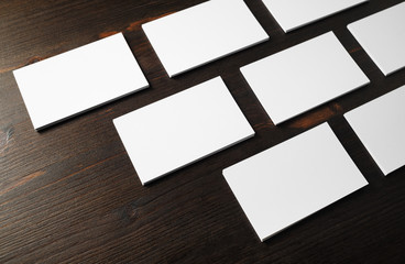 Photo of blank business cards on wood table background. Mockup for branding identity.