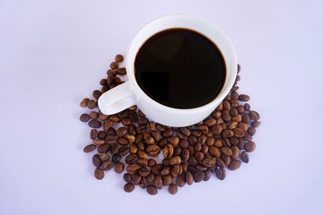 cup of coffee with beans on white background