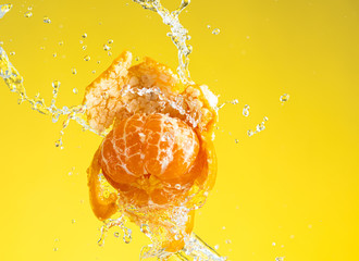 tangerine is almost peeled with a spray of water hanging © Vasily Popov