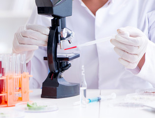 Female scientist researcher conducting an experiment in a labora