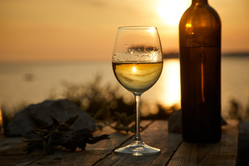 one glass with wine during sunset time