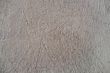 Asphalt close-up, wet concrete wall texture. Raw plaster wall background