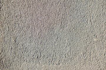 Asphalt close-up, wet concrete wall texture. Raw plaster wall background