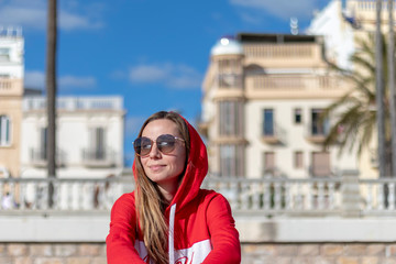 Fototapeta premium Pretty blonde girl on the beach with red jersey on the beaches of Barcelona
