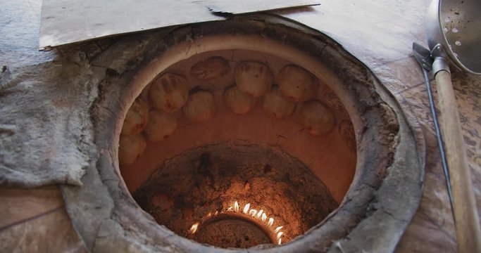 Famous Jizzakh (Jizzah) samsa in the owen (tandir) Samosa in the stove (tandoor) Uzbekistan, Central Asia.