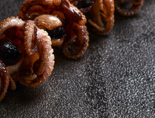 Yakiniku japanese street food closeup composition grilled octopus tentacles on a stick, freshly grilled seafood