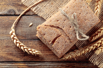 Rye crackers and ears on a old wooden table.
