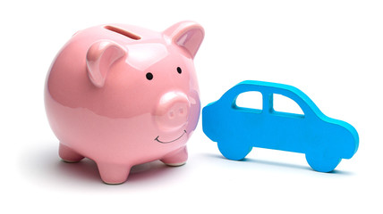 Pink piggy bank and blue car isolated on white background. Concept of saving money on buying a car or car on credit