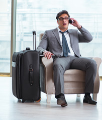 Fototapeta premium Young businessman in airport business lounge waiting for flight