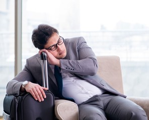 Young businessman in airport business lounge waiting for flight
