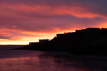 Dramatic sunset over the mountains and the sea in Iceland