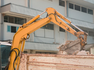 Bulldozer Removes the debris from demolition on the construction site