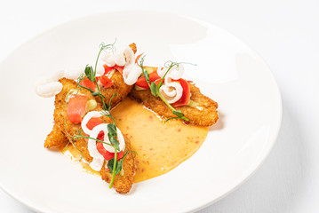 fried fish with vegetables and sauce