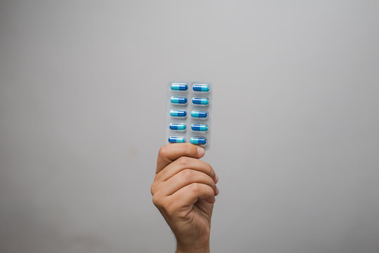 Hand Holding Pills In Blister Pack