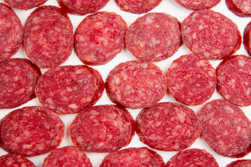 sliced ​​parts of sausage, salami on a white background. fast food and breakfast
