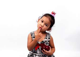 Cute asian baby girl portrait with holding apple fruits and touch to mouth Isolated on white backgrounds