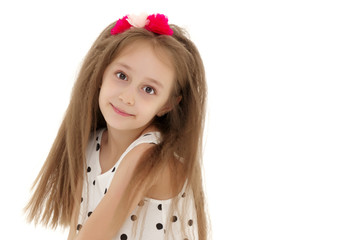 Little girl is sitting on the floor.