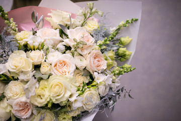 bouquet of white roses. Bouquet of natural fresh roses, tulips, anemones, peonies, buttercups, matiola, daffodil, cloves, eucalyptus. Bouquet of flowers decorated with a composition of flowers
