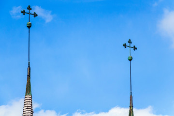Fototapeta na wymiar Church spire with tree clover at a blue sky
