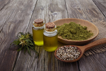 hemp oil, powder, seeds on wooden table