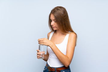 Young blonde girl with a bottle of water over isolated background