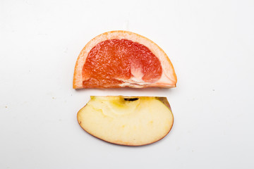 top view of a slice of an apple and a slice of an orange 