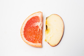 top view of a slice of an apple and a slice of an orange 