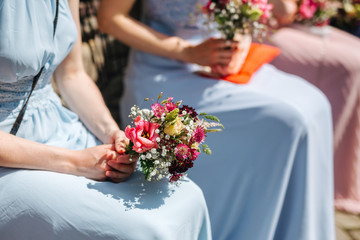Bridesmaid holding flowers close up