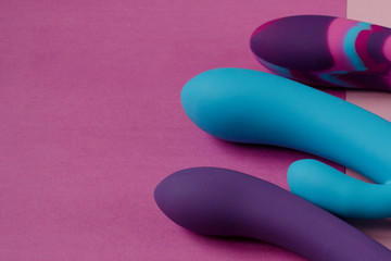 Three vibrators on bright background. Sex toys on pink background. Image for the sex shop