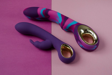 Vibrators. Two sex toys on bright background. Purple intim toys. Image for the sex shop