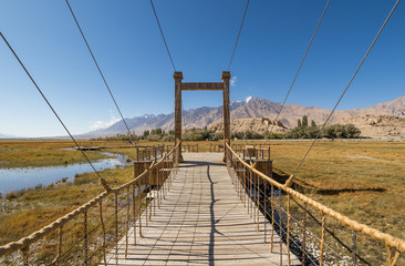 Fototapeta premium Tashkurgan is slowly becoming a tourist attraction with people coming from all over China. Here in particular some footboards to help people visiting the grassland